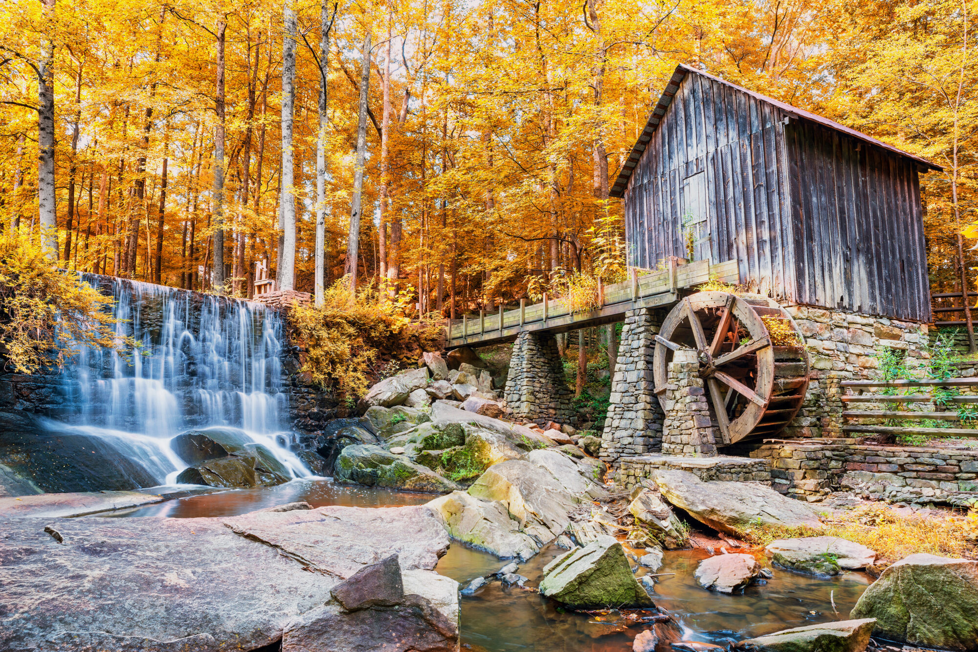 Fall or Autumn image of historic mill and waterfall in GA
